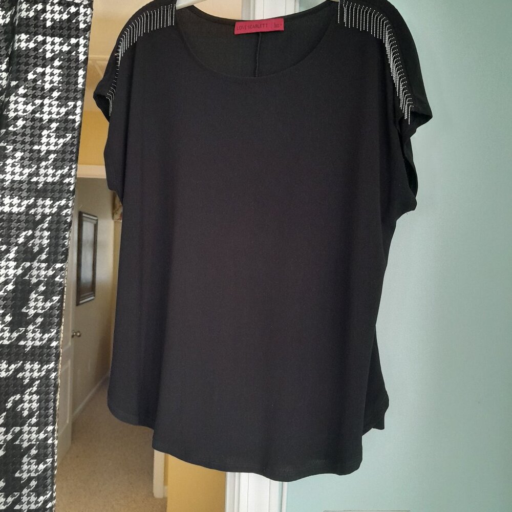 Ladies black top with silver metal fringe at short sleeves